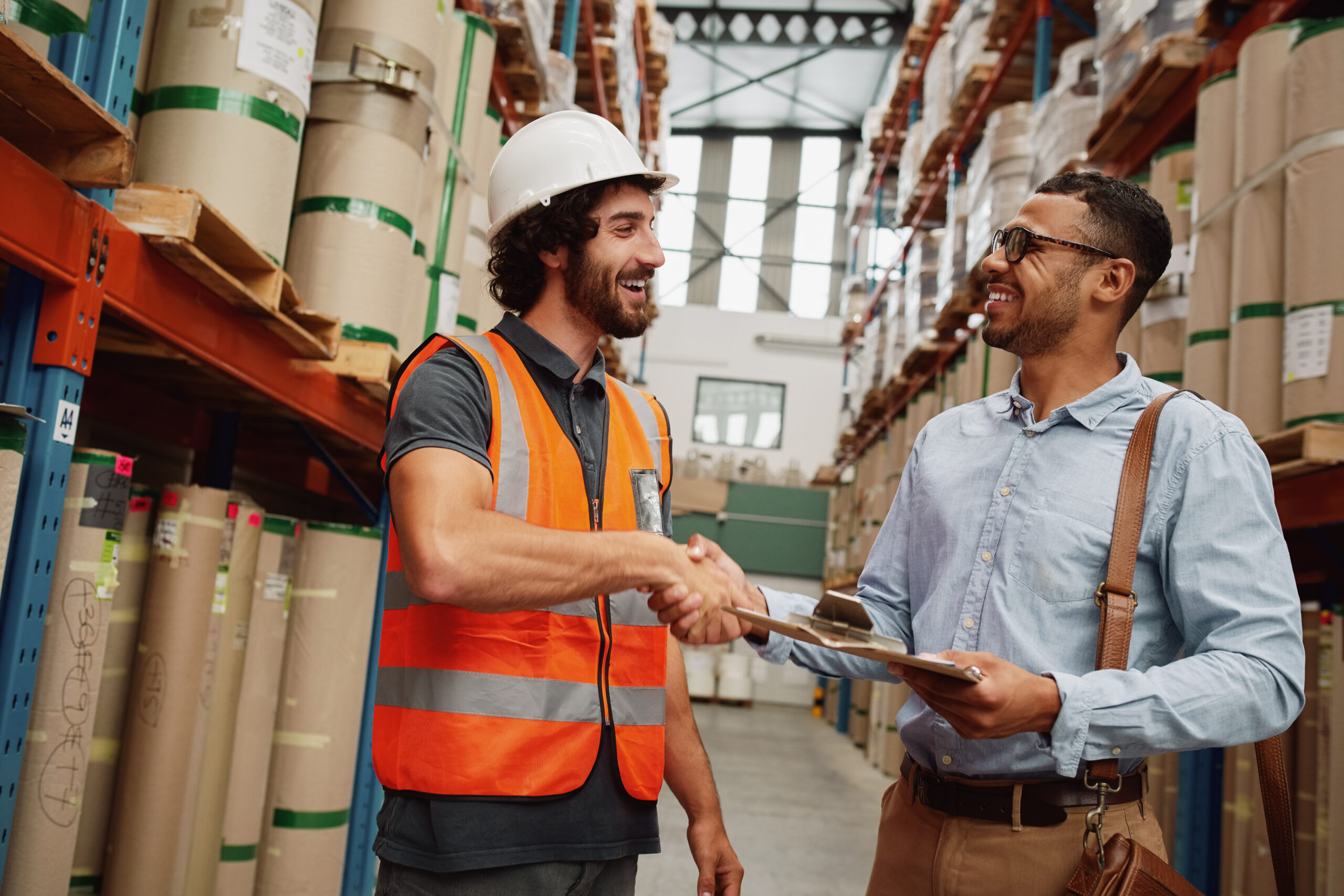 two men in a warehouse shaking hands