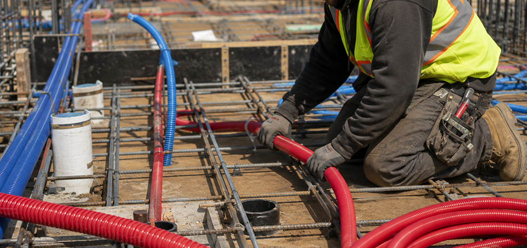 A man installing pex products in a building.